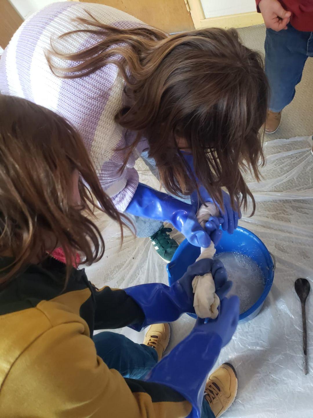 Les élèves récoltent les draps qui serviront à la confection de la voile.